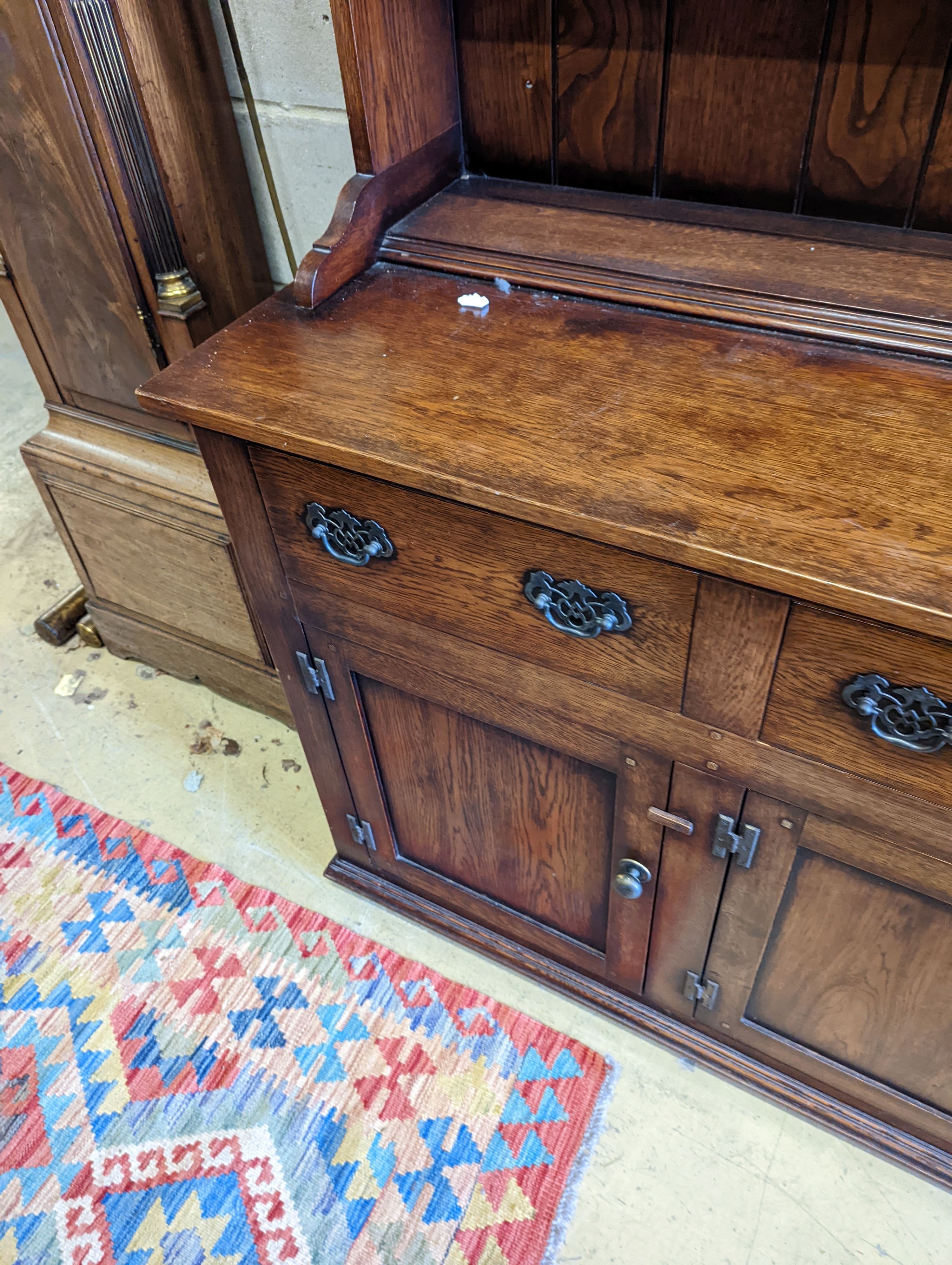 An 18th century style oak dresser with boarded plate rack, width 199cm, depth 48cm, height 198cm